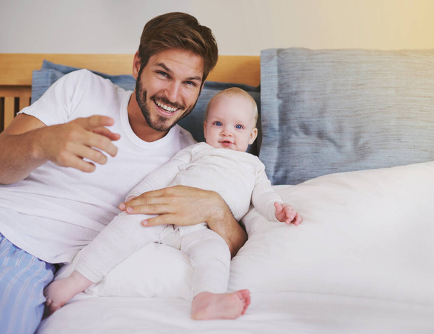 Family, bedroom and portrait of father with baby for bonding, relationship and love for parenting. Happy, home and dad relax with newborn infant for child development, support and care in house. - Photo, Image