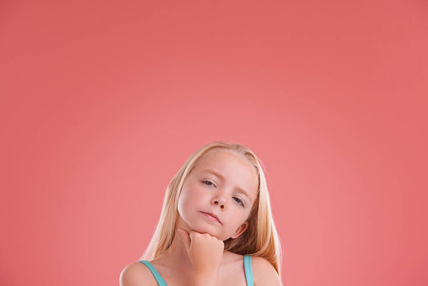 Planning, ideas and girl child in studio with brainstorming facial expression by mockup space. Thinking, question and young kid model with guess, decision or choice face isolated by pink background - Φωτογραφία, εικόνα