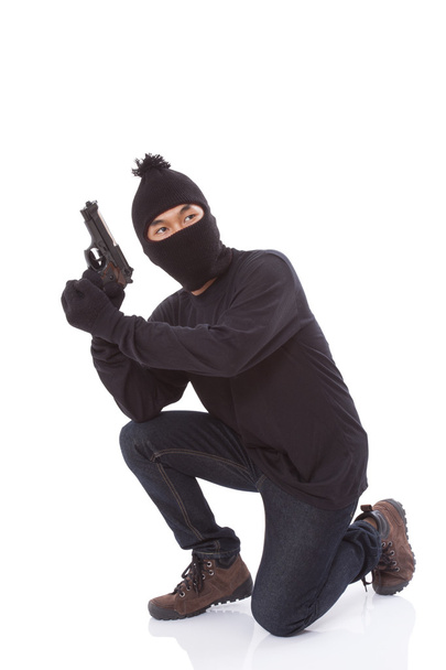 Man in a mask with a gun on a white background - Fotografie, Obrázek