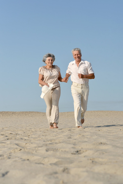 Senior couple running barefoot - Foto, Imagem