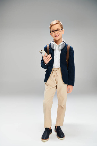 A preadolescent boy wearing glasses and a blue jacket. - Photo, Image