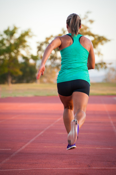 Female runner on an athletics track - Photo, Image