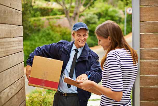 Box, clipboard and deliveryman with woman at her home gate for ecommerce shipping package. Outdoor, order and courier driver with cardboard parcel with female person for signature at house entrance - Photo, Image