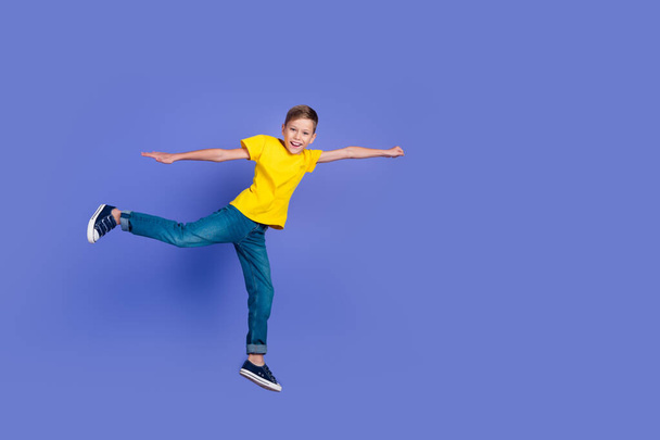 Full length photo of cheerful funny boy wear trendy clothes raise fist super mission empty space isolated on violet color background. - Foto, immagini