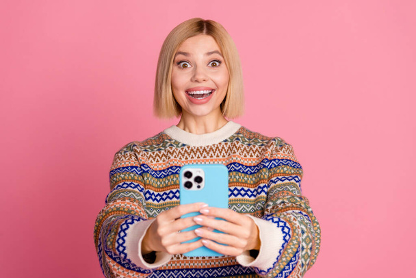 Photo of impressed girl with bob hair wear ornament sweater astonsihed staring on fast internet speed isolated on pink color background. - Фото, зображення