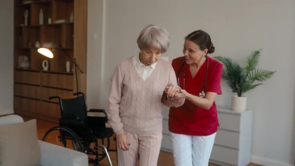 Jonge dochter die zorgt voor gepensioneerde moeder met lichamelijke of geestelijke stoornis. Vrouw helpt oudere moeder bij herstel delen van liefde en steun - Video
