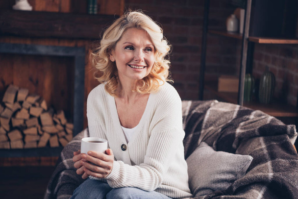 Photo portrait of lovely retired woman coffee look empty space wear casual clothes cozy home interior living room in brown warm color. - Foto, Bild
