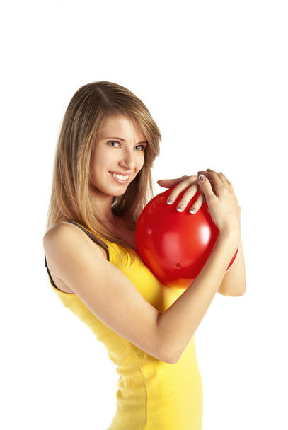 Smiling blond girl with red ball - Zdjęcie, obraz