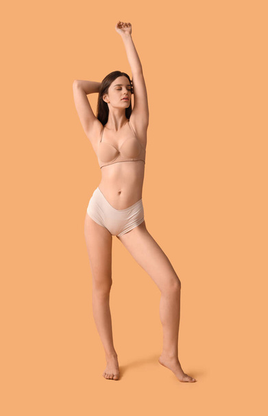 Body positive woman in underwear on beige background - Photo, Image