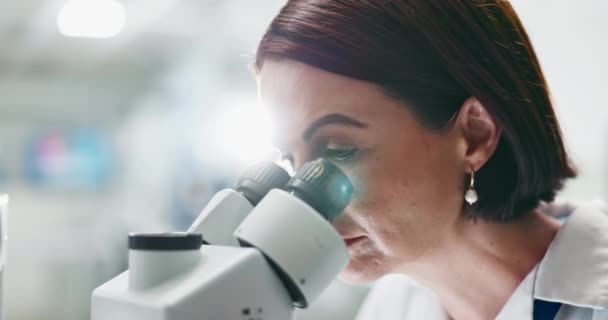 Woman, scientist and forensic study with microscope for science, microbiology or research at lab. Closeup of person or researcher looking in scope or lens for scientific breakthrough or discovery. - Footage, Video