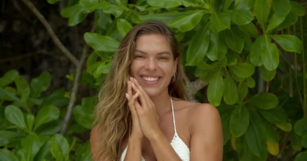 Face, smile and woman blowing a kiss by a tree of leaves on summer vacation, holiday in nature and flirting. Love, outdoor and young tourist laughing on a tropical island paradise for romance or care. - Footage, Video