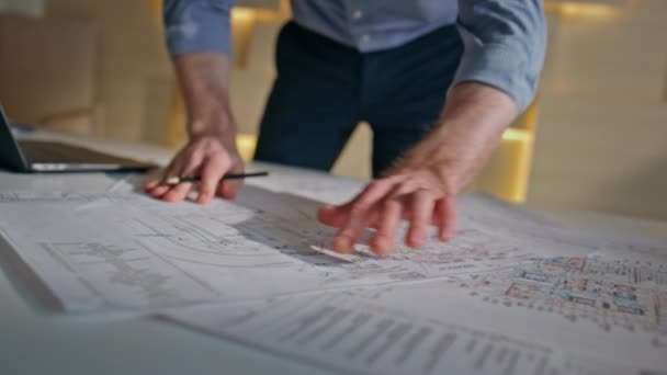 Engineer hands drawing at plan building on office table close up. Focused professional architect working at construction blueprint in architectural company. Serious man builder pointing plan by pencil - Footage, Video
