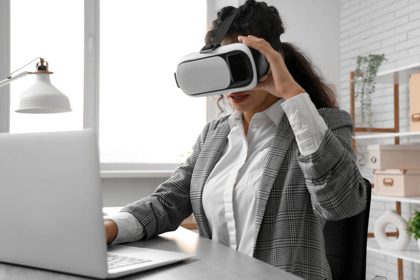 Junge afroamerikanische Geschäftsfrau mit VR-Brille arbeitet im Büro - Foto, Bild