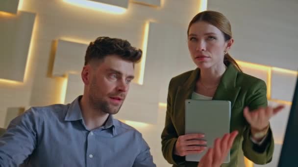 Two colleagues worried business failure in modern office close up. Serious businesswoman dissatisfied by manager work complaining on mistakes. Displeased businessman feeling stress looking on computer - Footage, Video