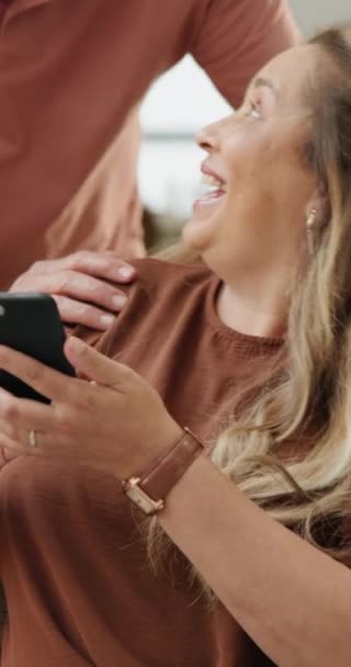 Home, old couple and cellphone with typing, smile and conversation with social media and connection. Apartment, senior man and mature woman with smartphone and contact with internet or digital app. - Footage, Video