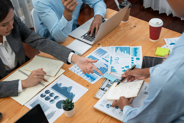 Multiracial analyst team use BI dashboard data to analyze financial report on meeting table. Group of diverse business people utilize data analysis by FIntech for business marketing decision. Concord - Photo, Image
