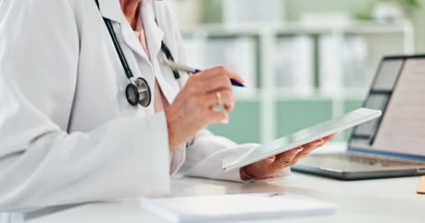 Doctor, hands and writing with notebook or tablet for prescription, schedule or results at office. Closeup of person or medical employee taking notes with technology for script or diagnosis on desk. - Felvétel, videó