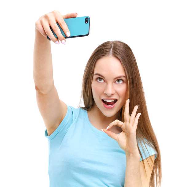 Beautiful young woman taking a picture of herself with her camer - Foto, Imagen