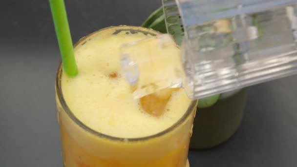 Adicionar gelo a uma refrescante bebida de verão com gelo e frutas cítricas. Imagens 4k de alta qualidade - Filmagem, Vídeo