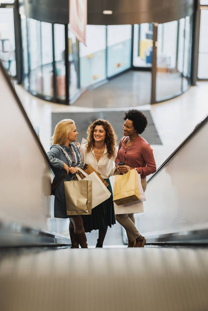Shot of three attractive girlfriends smiling while enjoys a day of shopping in a mall. - Photo, Image