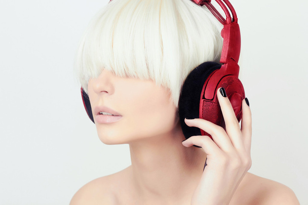 Woman listening music on headphones - Fotó, kép