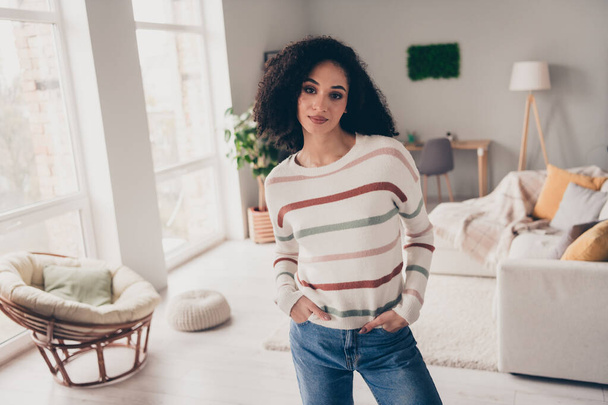 Photo of positive cheerful lady dressed striped pullover enjoying staying home indoors apartment room. - Foto, afbeelding