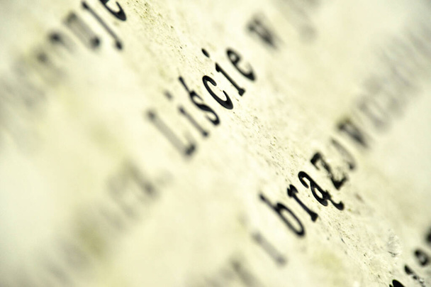 a close-up of text, specifically the letters, - Photo, Image