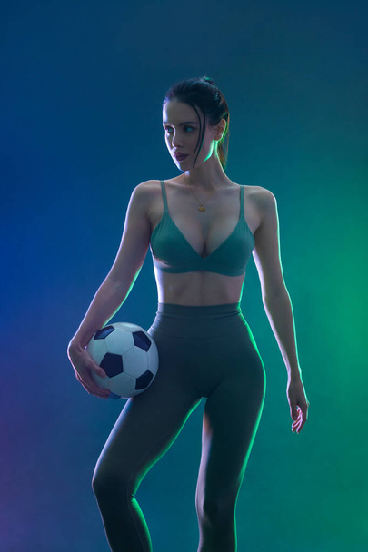 Soccer player. Athlete in football sportswear on game with ball. Sport concept - Foto, afbeelding