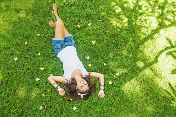 Young woman relaxing on a grass - Foto, Imagem