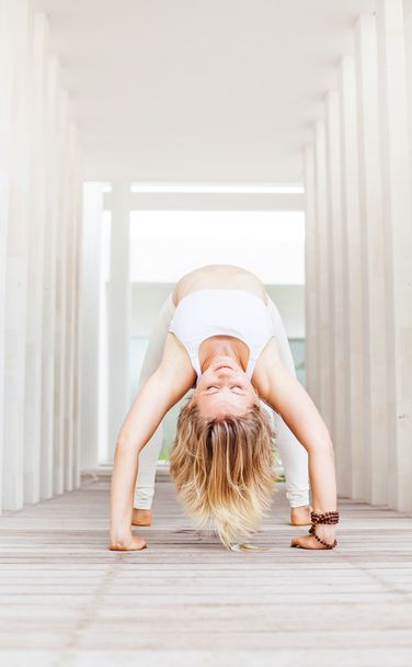 Young mighty woman doing yoga - Фото, изображение