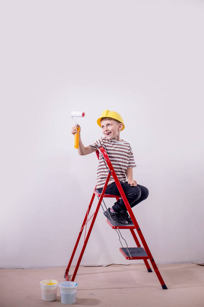 Boy painting wall during home renovation - Fotó, kép