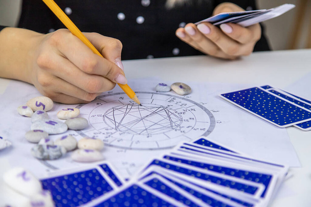 Woman astrologer draws a natal chart. Selective focus. People. - Foto, immagini