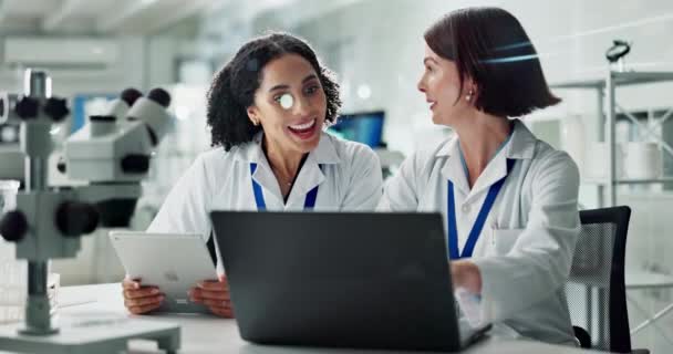 Women, partner and scientist in laboratory with high five, laptop and success with results for innovation. People, teamwork and support for science, celebration and data analysis for pharma research. - Footage, Video