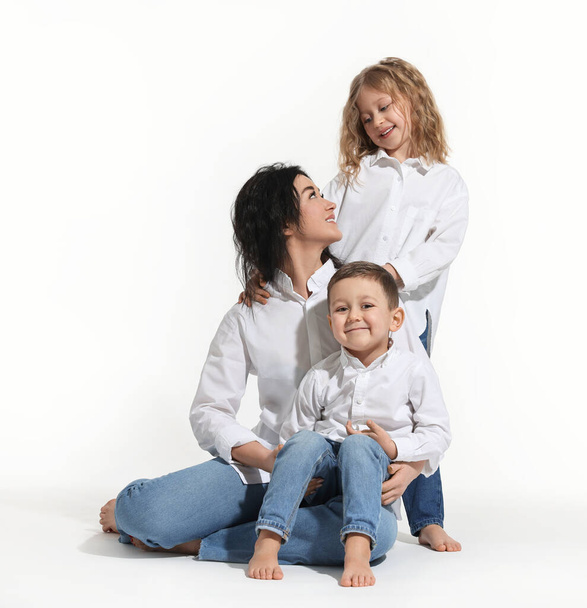 Little children with their mother on white background - Фото, изображение