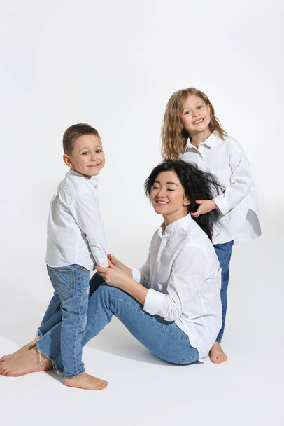 Little children with their mother on white background - Foto, imagen