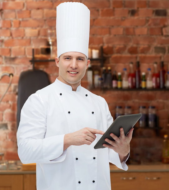 happy male chef cook holding tablet pc - Foto, Bild