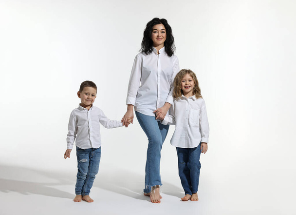Little children with their mother on white background. Space for text - Photo, image