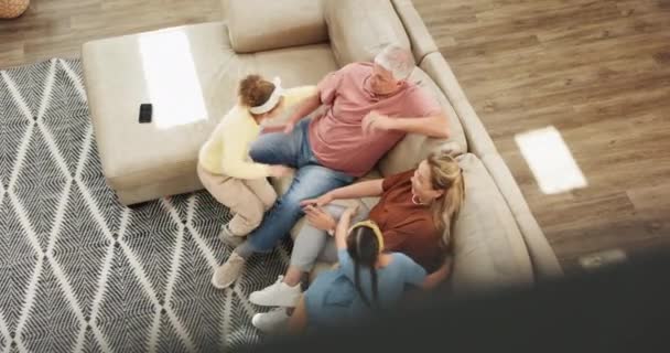 Grandparents, children and hug on sofa with happiness for bonding, relax and top view in living room of home. Family, senior couple and kids with embrace on couch of lounge with talking, love or care. - Footage, Video