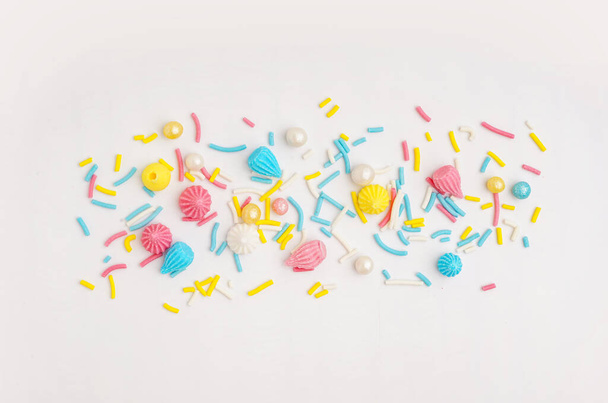 Sweet colorful sprinkles scattered on white background - Photo, Image