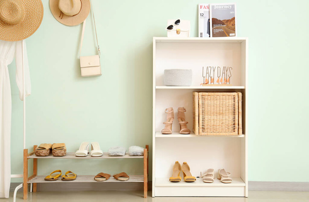 Shelf with shoes and shelving unit in room - Photo, Image