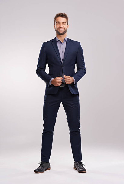 Portrait, studio and happy businessman with confidence, corporate fashion and pride. Salesman, consultant or entrepreneur man in business suit with stylish gentleman clothes on white background. - 写真・画像