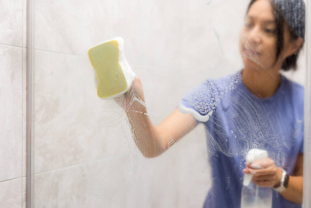 Woman clean the hard water stains and deposits in bathroom - Photo, Image