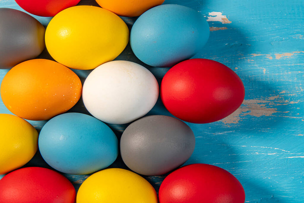 huevos pintados en diferentes colores para simbolizar el paso de la Pascua cristiana - Foto, Imagen