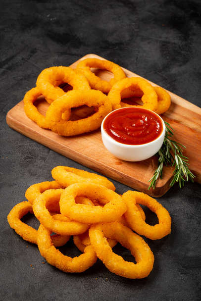 Crispy onion rings with ketchup. - Photo, Image