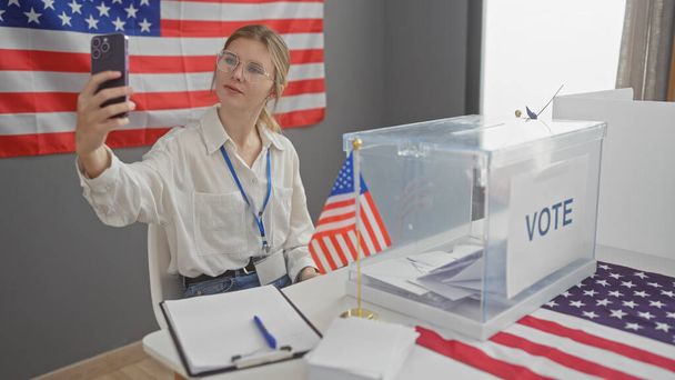 Young woman taking a selfie at a usa voting center, with ballot box and american flag in foreground - Photo, Image