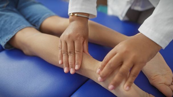 Therapist woman treats child patient in a physiotherapy room. - Photo, Image