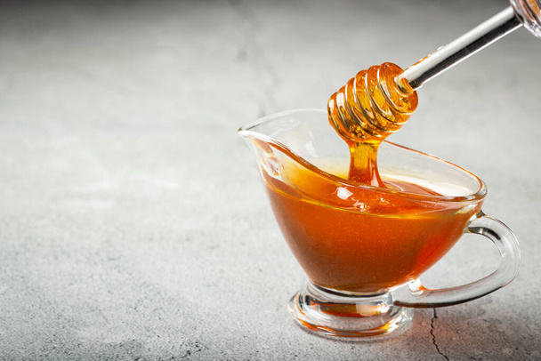 Honey in glass bowl on the table. - Photo, Image
