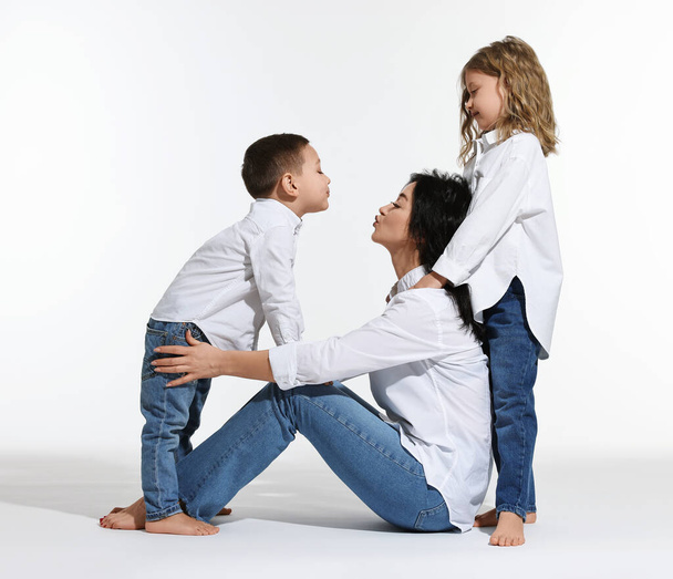 Little children with their mother on white background - Photo, Image