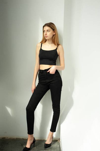 young pretty girl with a black hair and black pants - Photo, Image