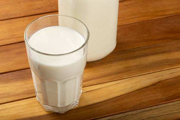 Glass of milk on the wooden table. - Photo, Image